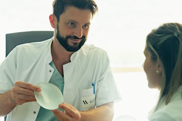 Photo d'un chirurgien spécialiste du sein en consultation avec une patiente.