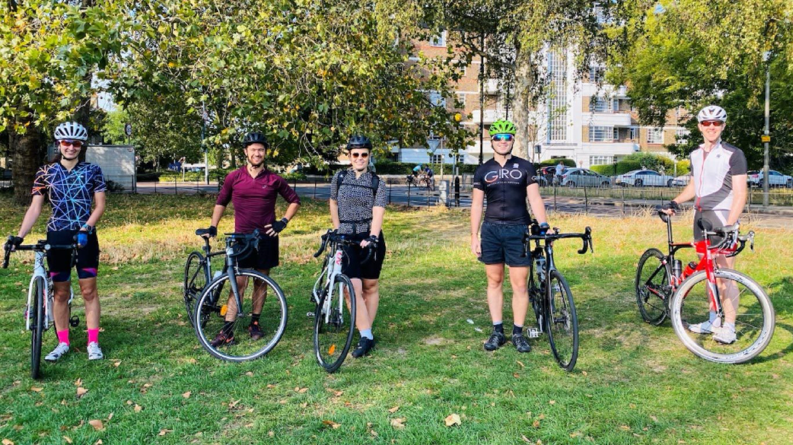 Five Alfa employees in Clapham Park with their bicycles