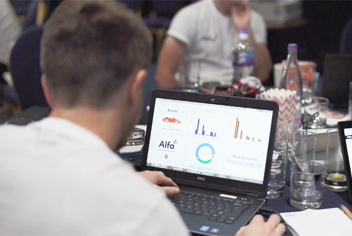 Alfa employee on a laptop looking at a screen