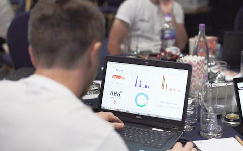 Alfa employee on a laptop looking at a screen
