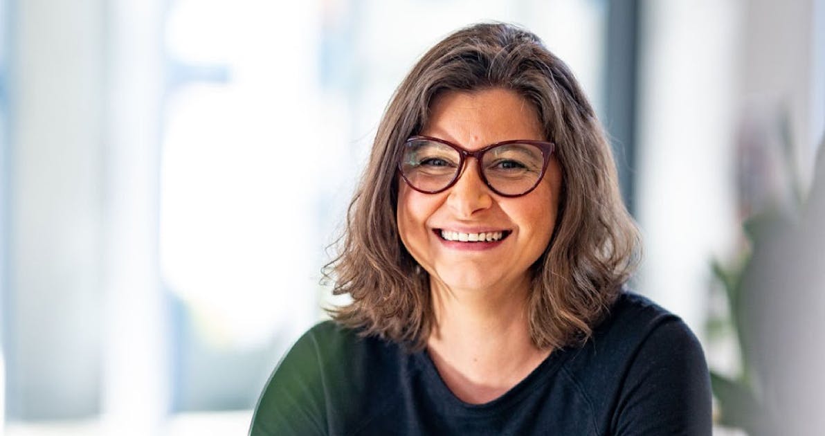 Female Alfa employee smiling at the camera