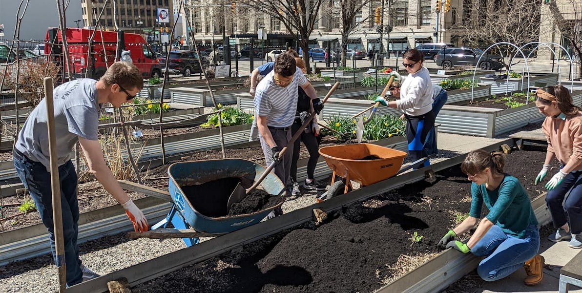 alfa employees working in a public garden