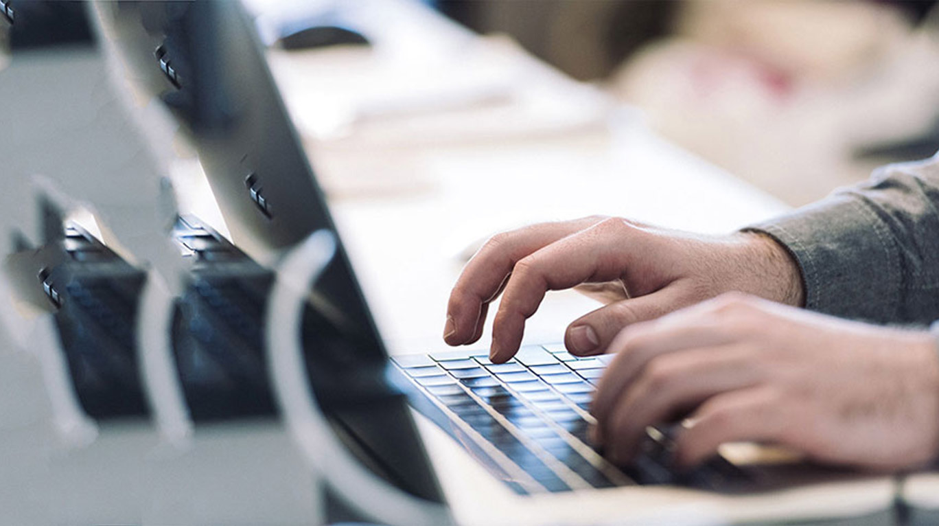 Man typing on the computer keyboard