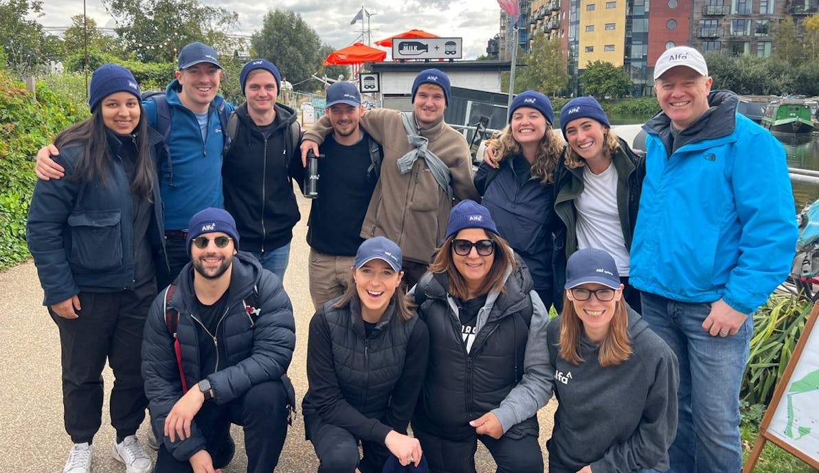 a group of Alfa employees at a canal cleanup