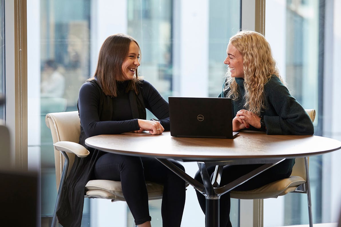 two women at alfa smiling in discussion