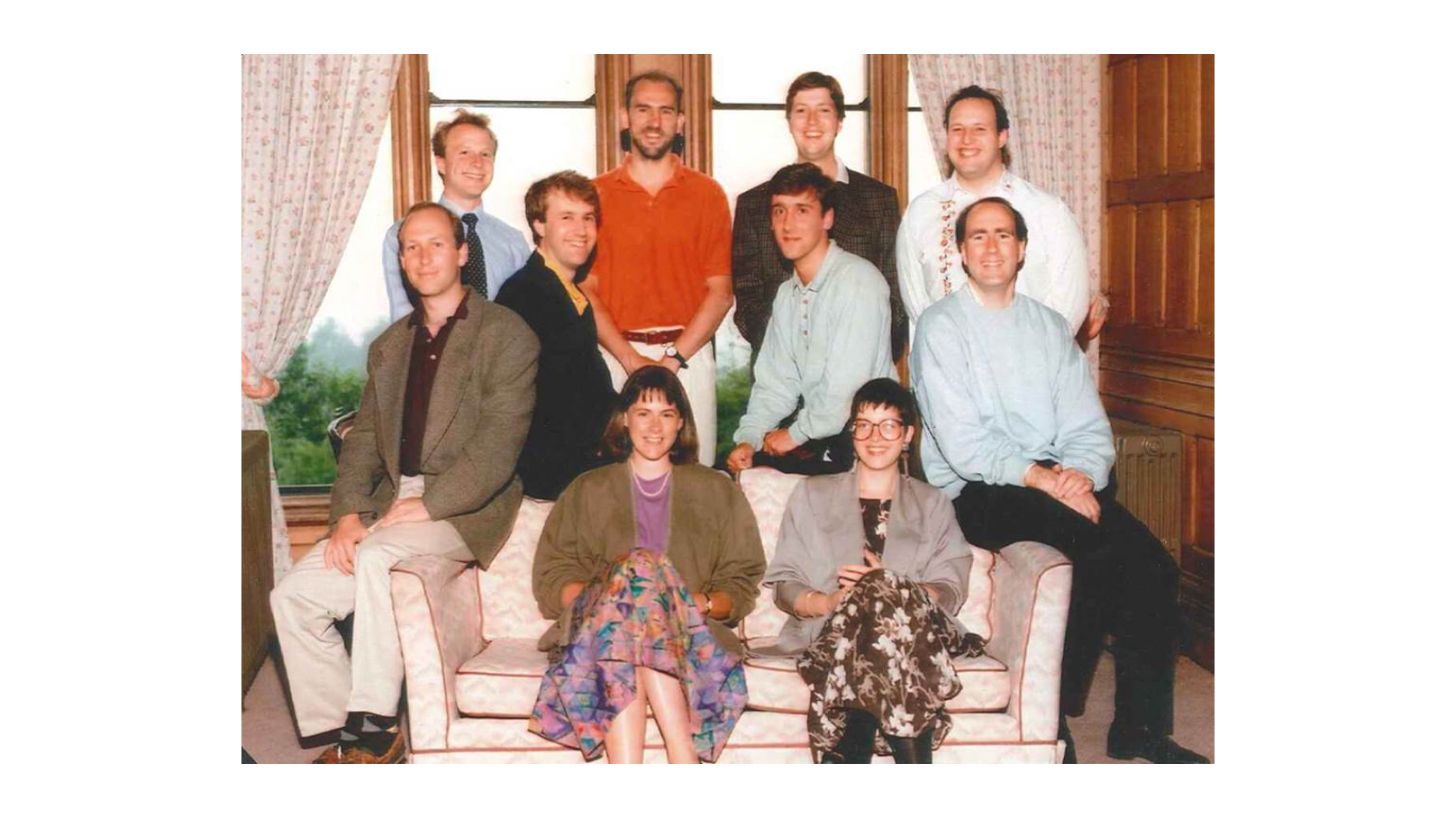Founding members of CHP Consulting sitting on a sofa in 1990