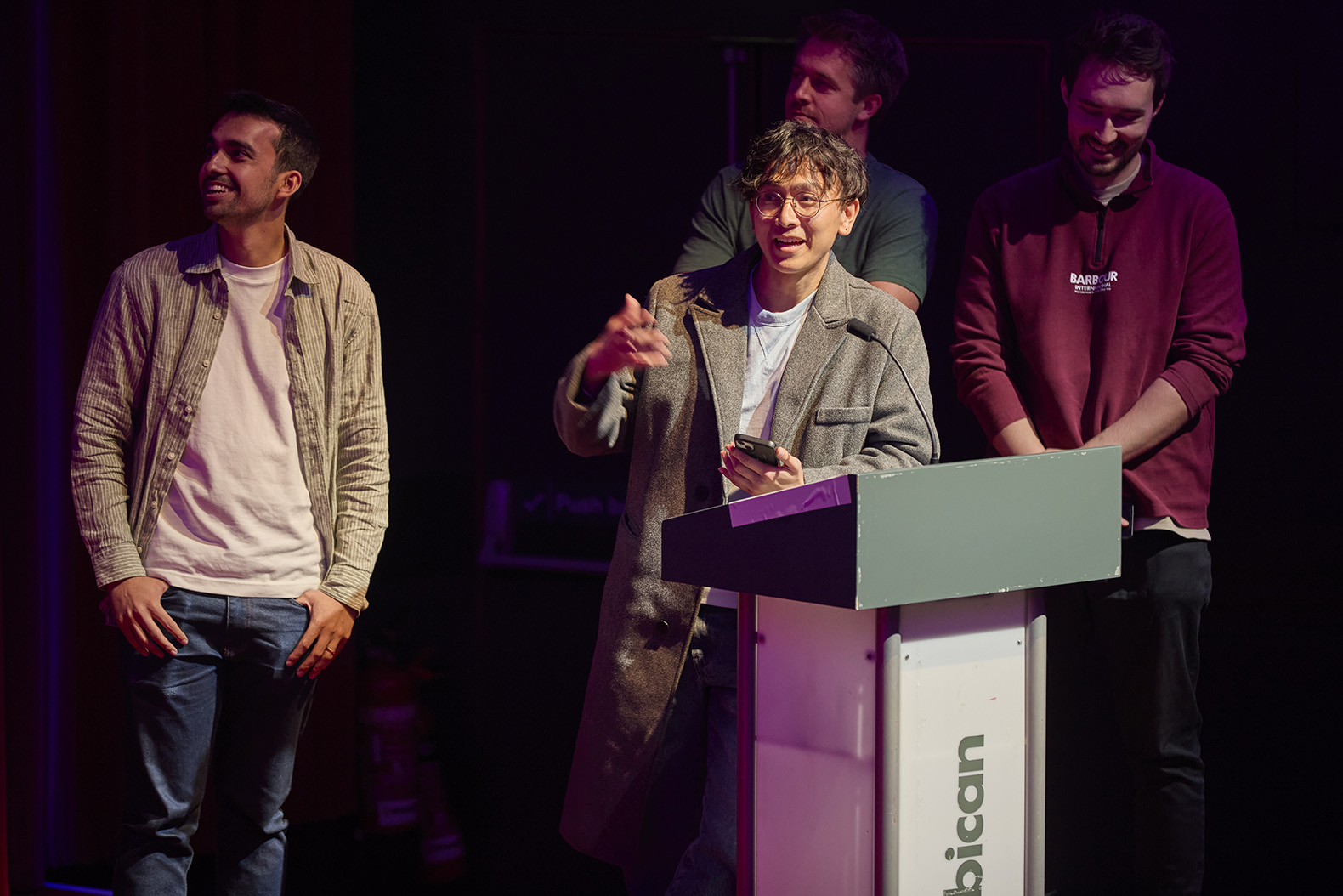 Group of four Alfa employees presenting on stage