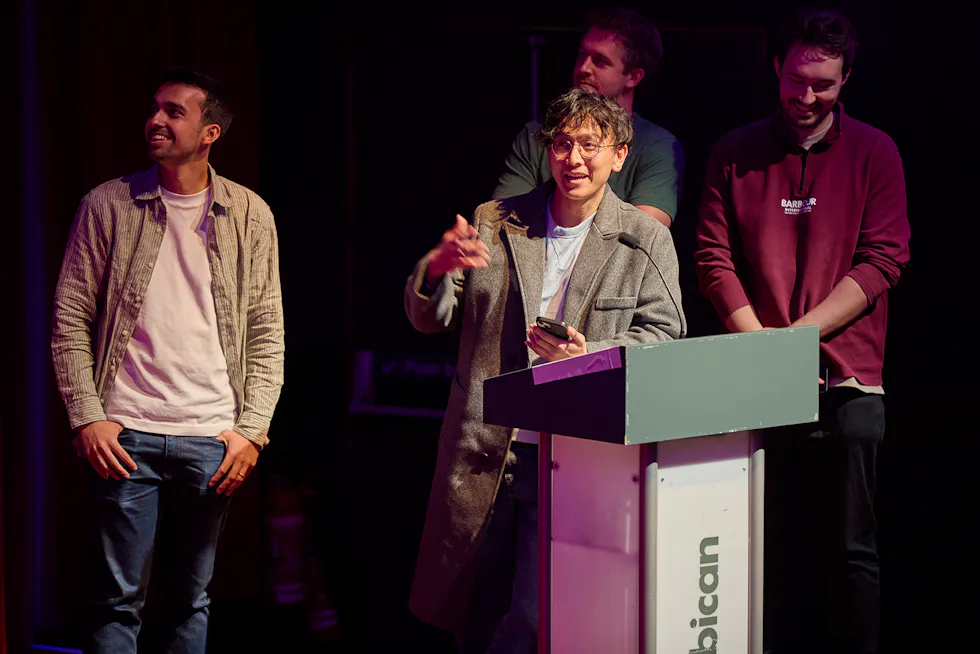 Group of four Alfa employees presenting on stage