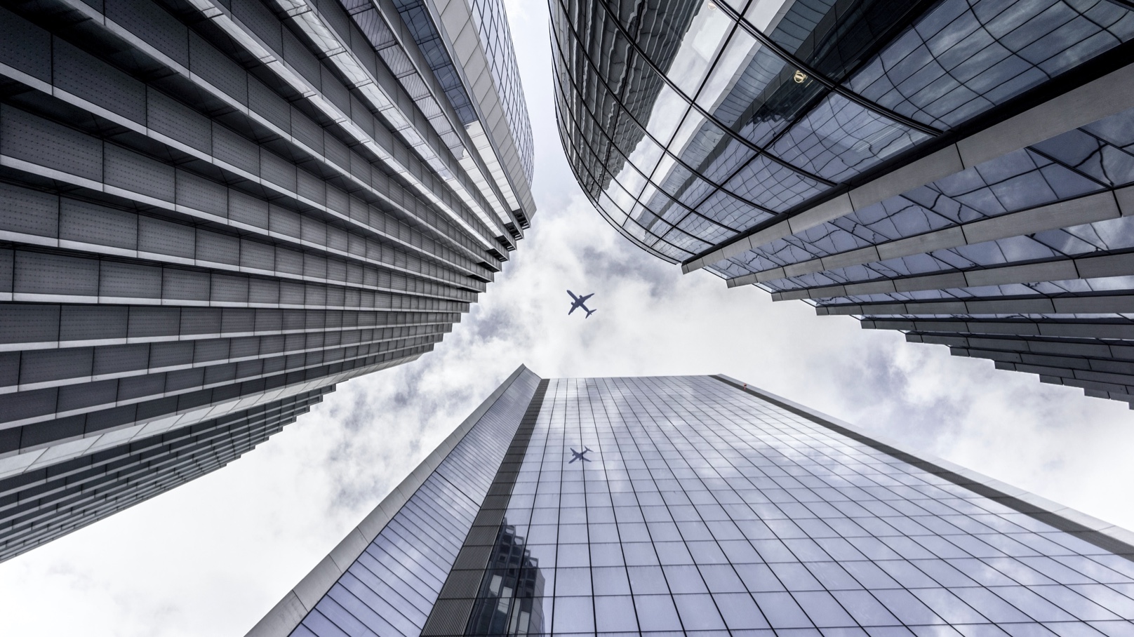 Plane Flying Over High-rise Buildings