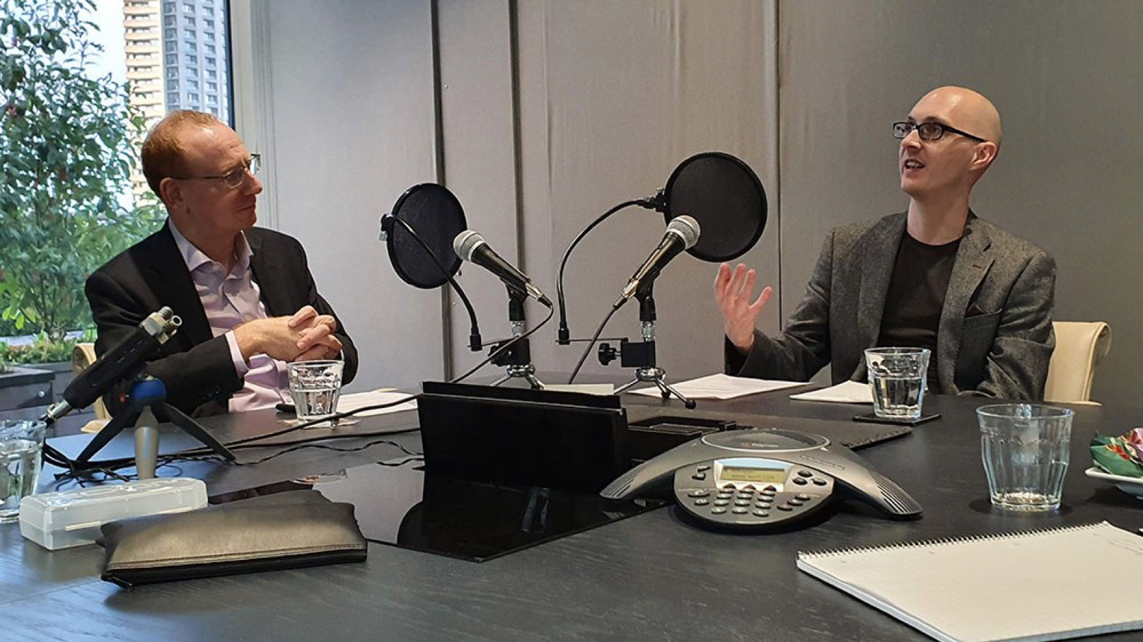 Alfa's Andrew Flegg talking in a recording studio for a podcast about AI