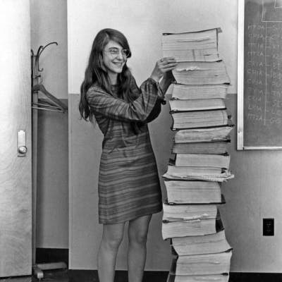 Margaret Hamilton with a tower of books