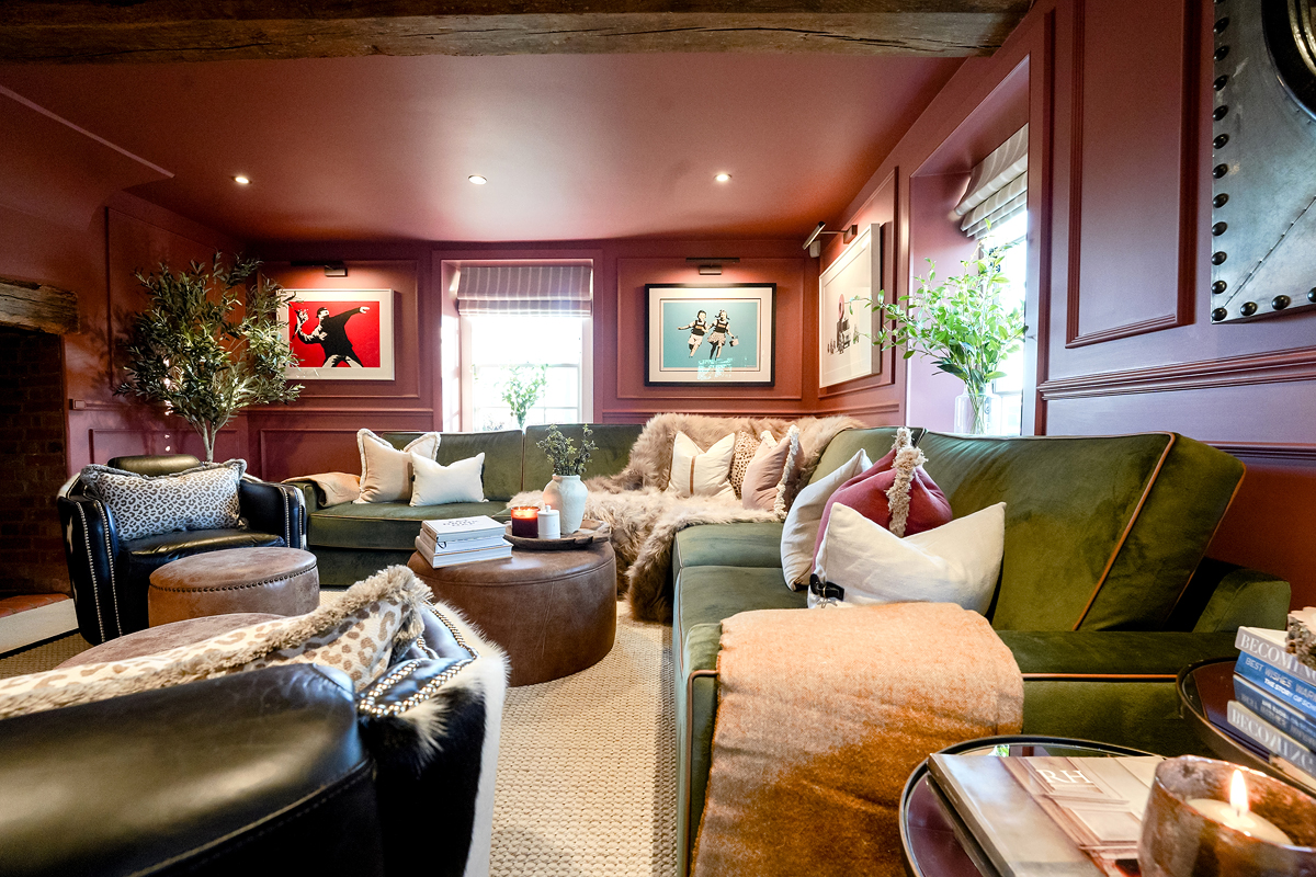 luxury living room with dark blush walls and green velvet sofa