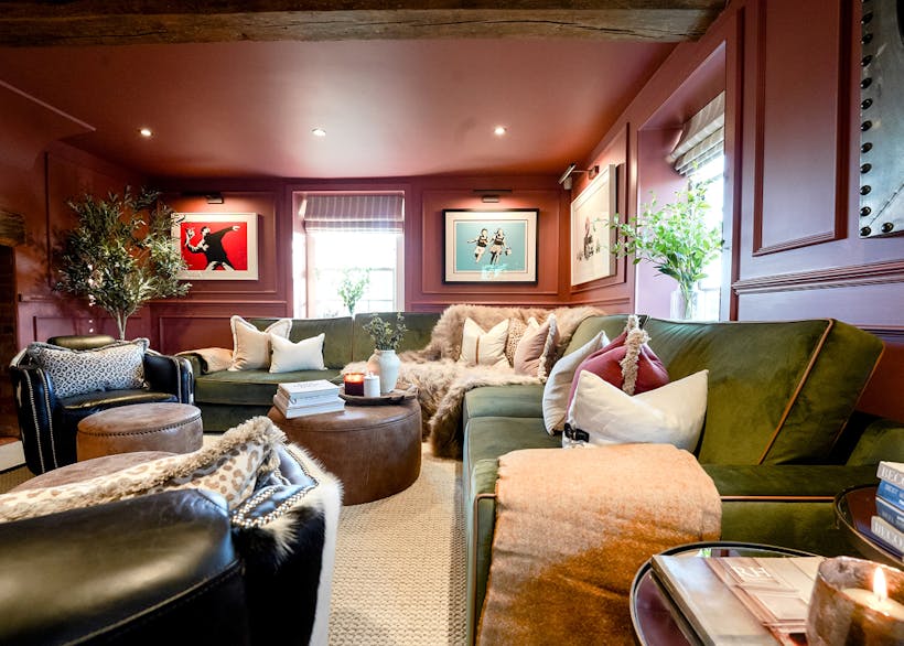luxury living room with dark blush walls and green velvet sofa