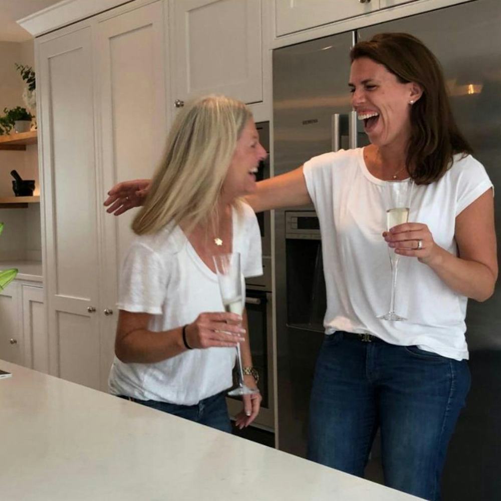 Laughing with a glass of bubbly