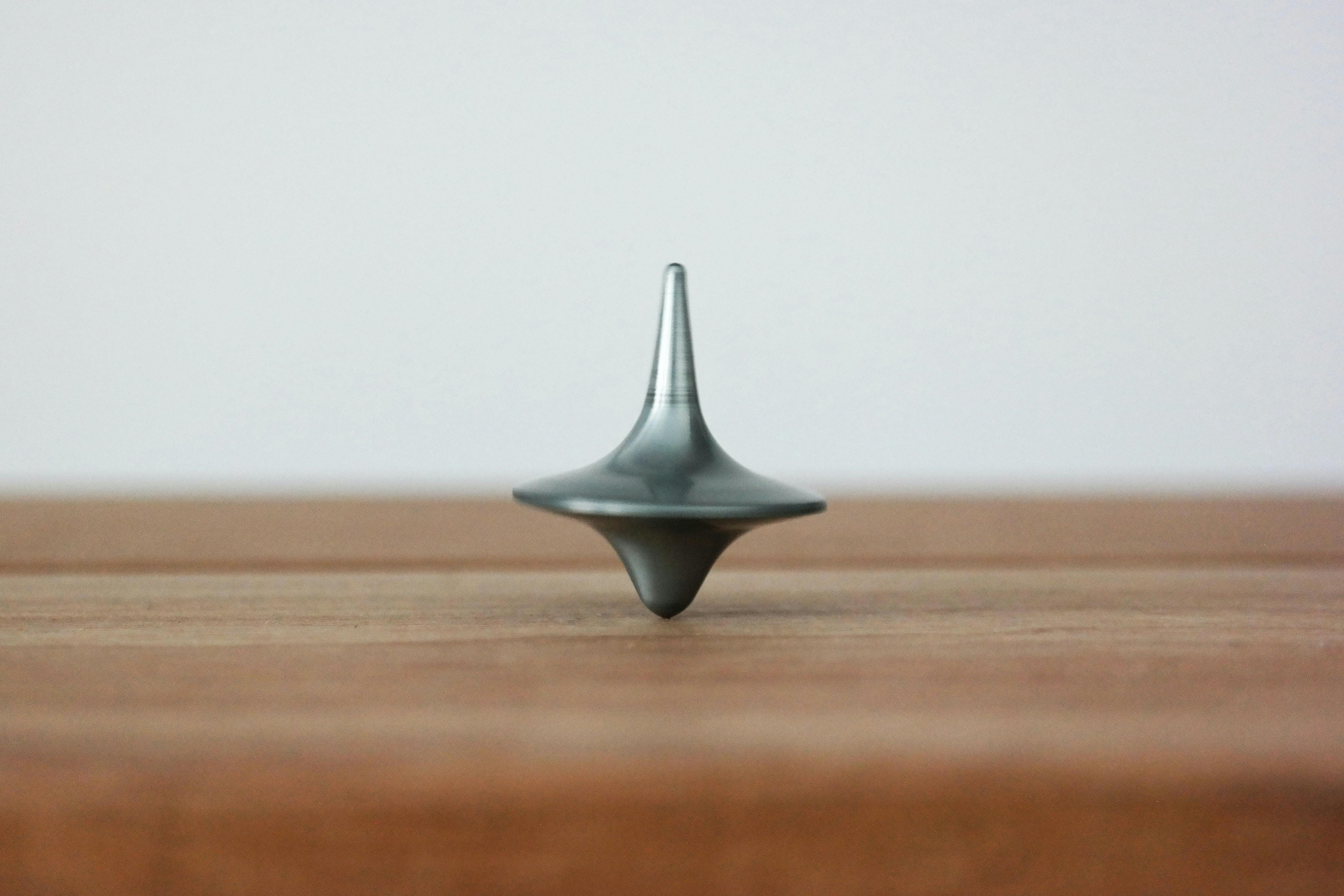 a black top spinning on a wooden table