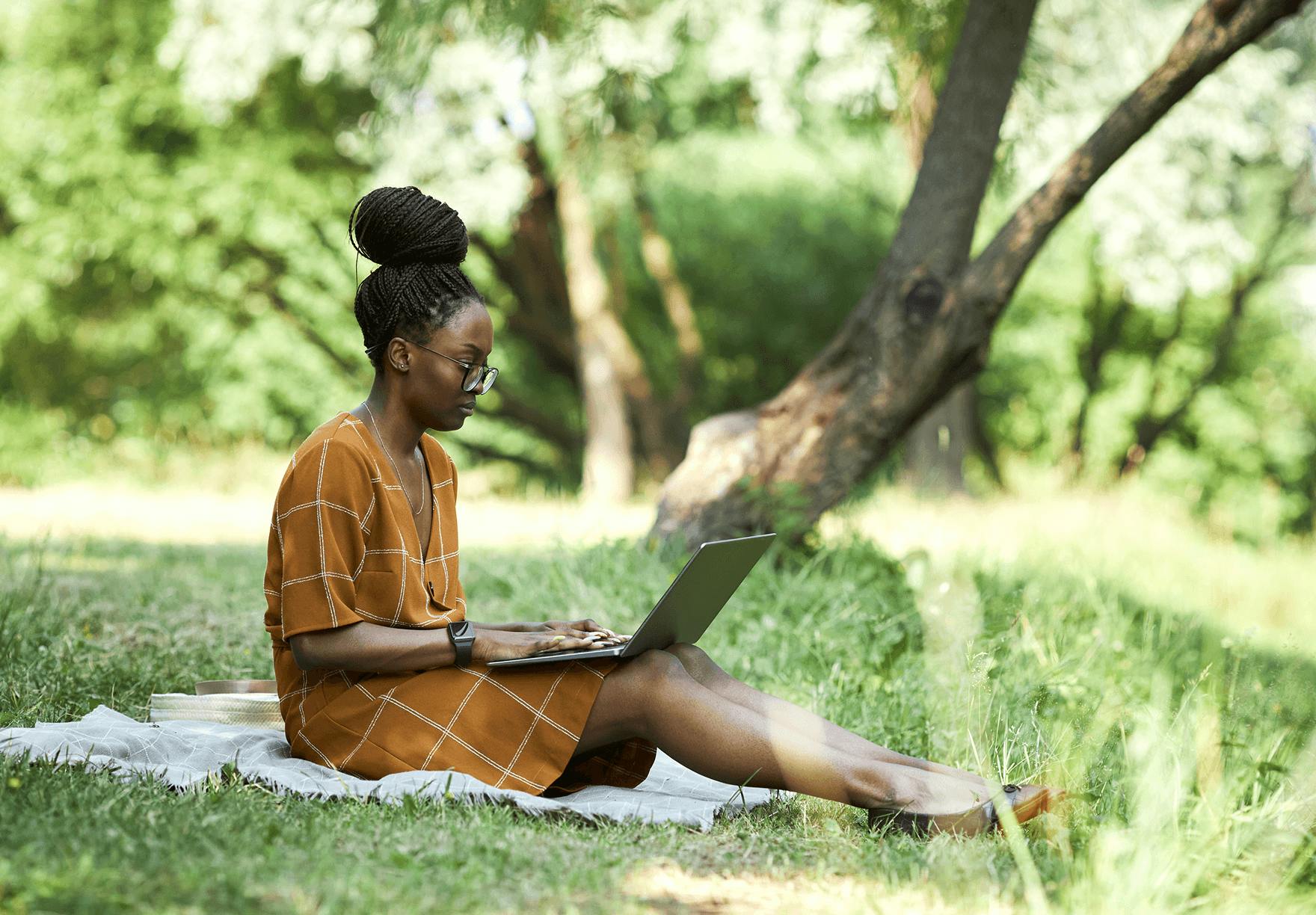 Woman working on laptop in the garden 