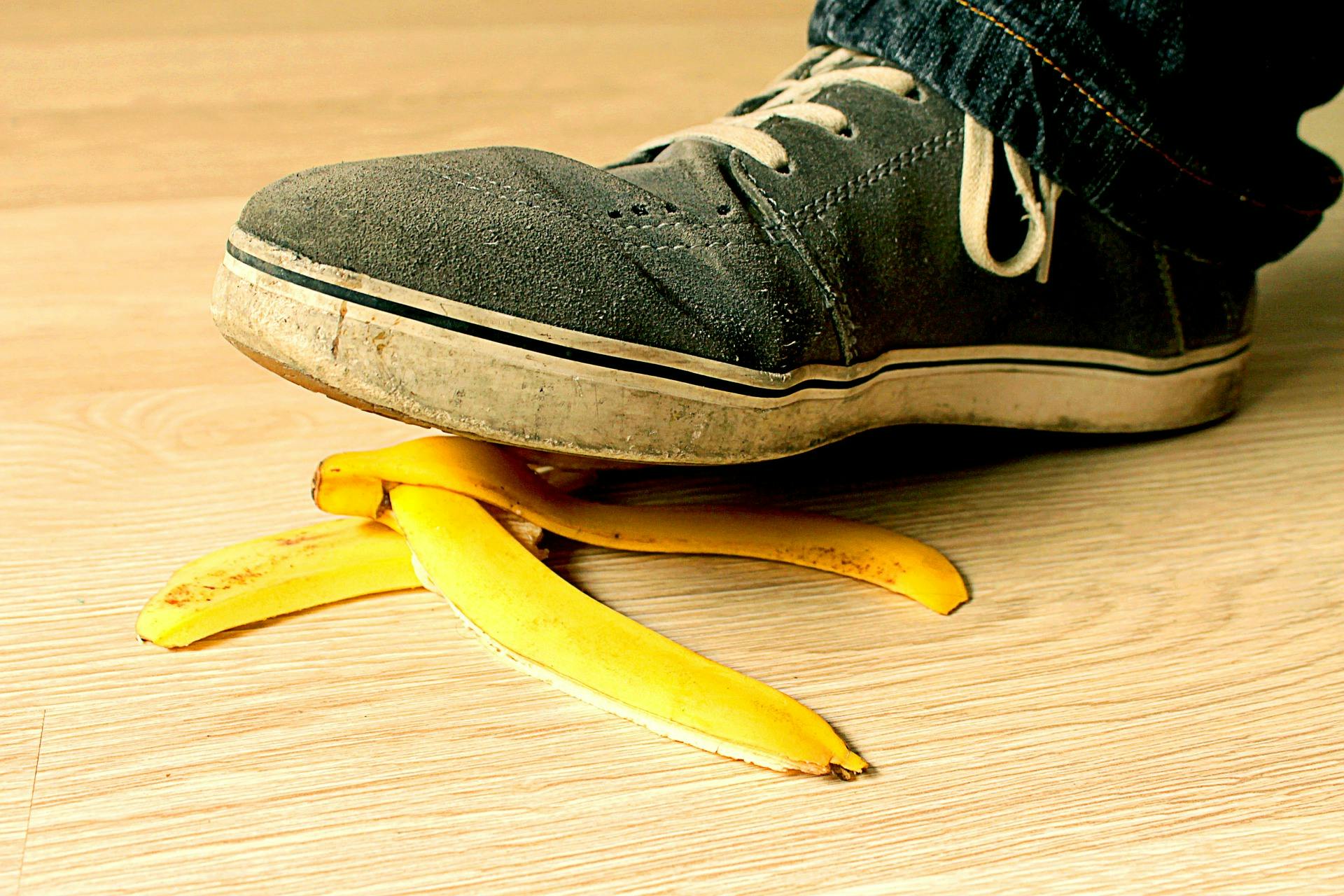 black shoe stepping on banana peel