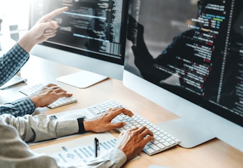 two people working on some code together