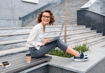 woman sitting with her laptop on stairs