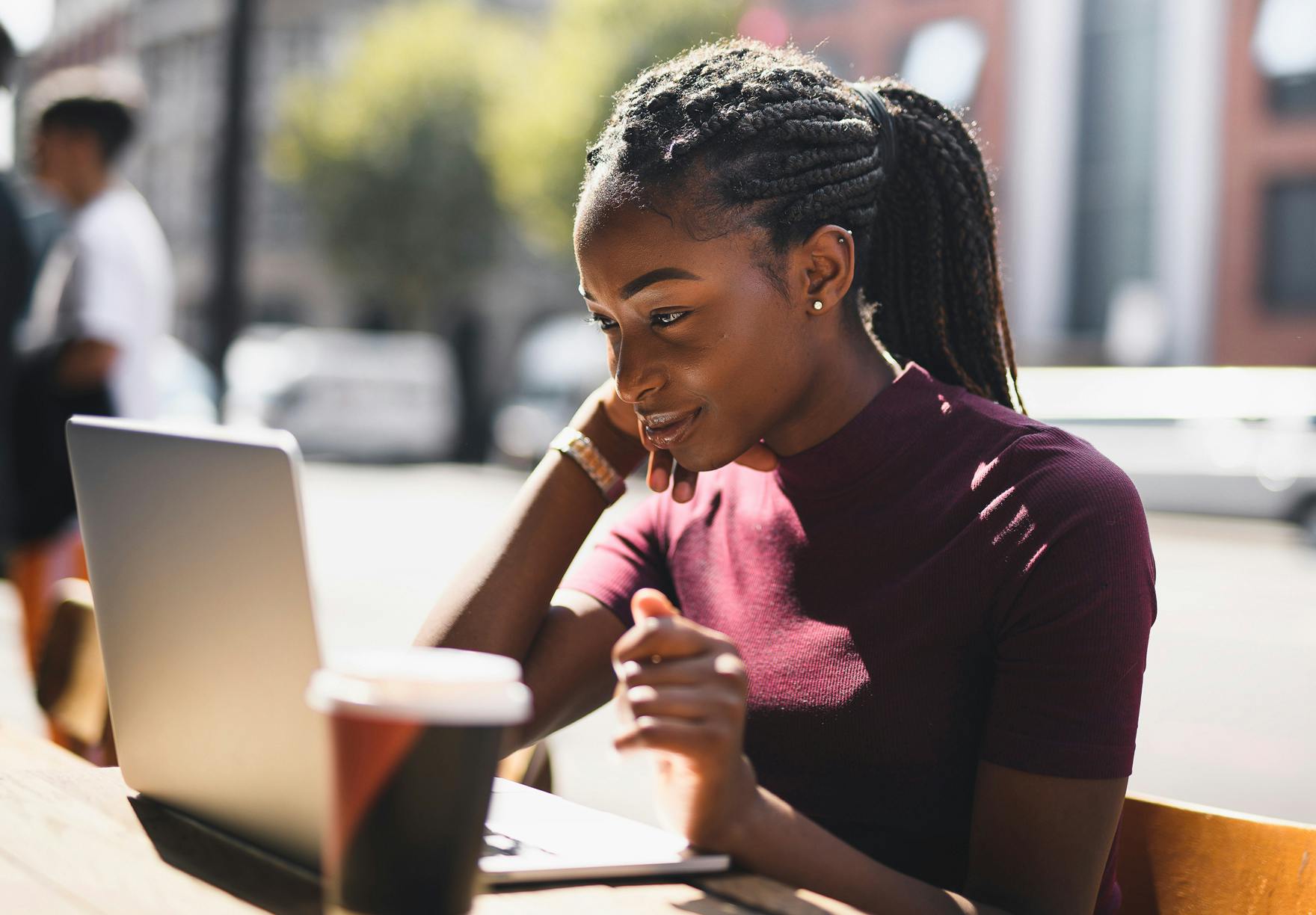 Smiling woman happily working outside for her new remote job