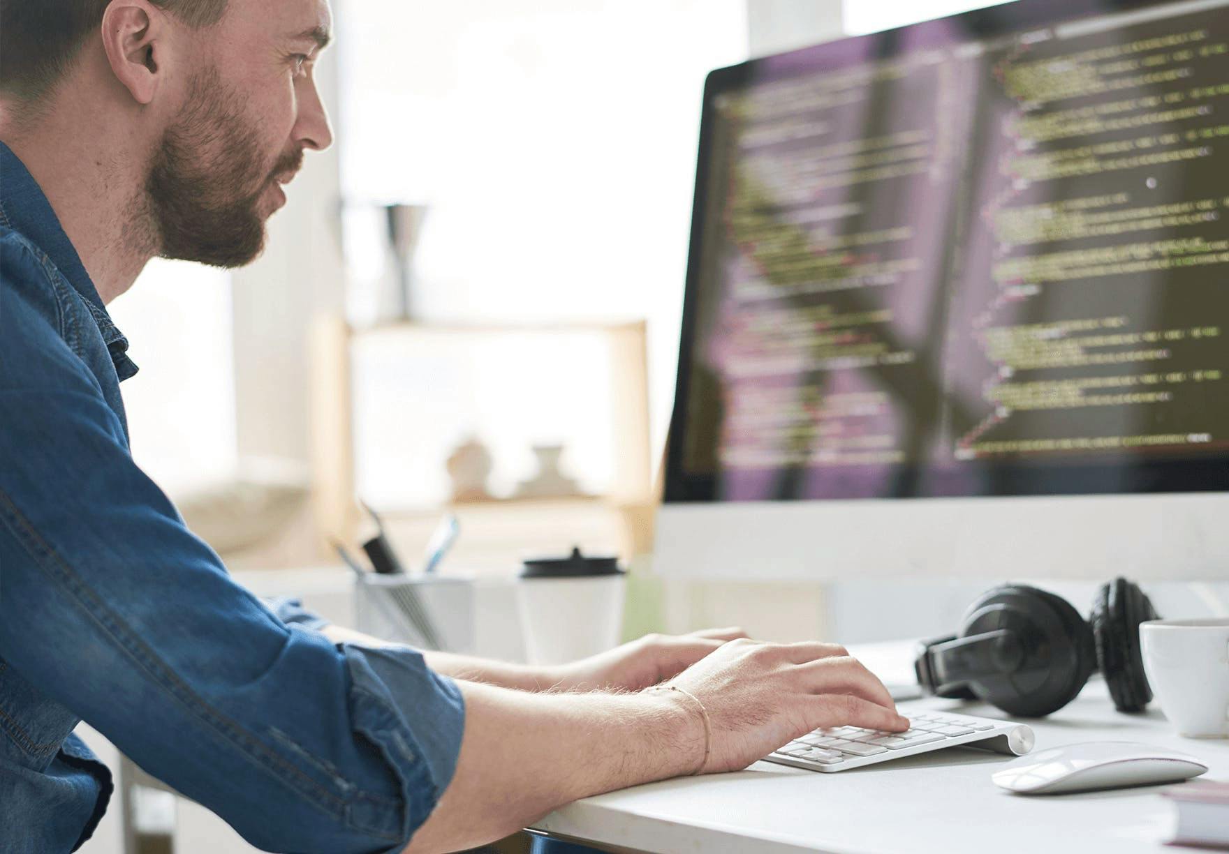 Man working on code at a computer