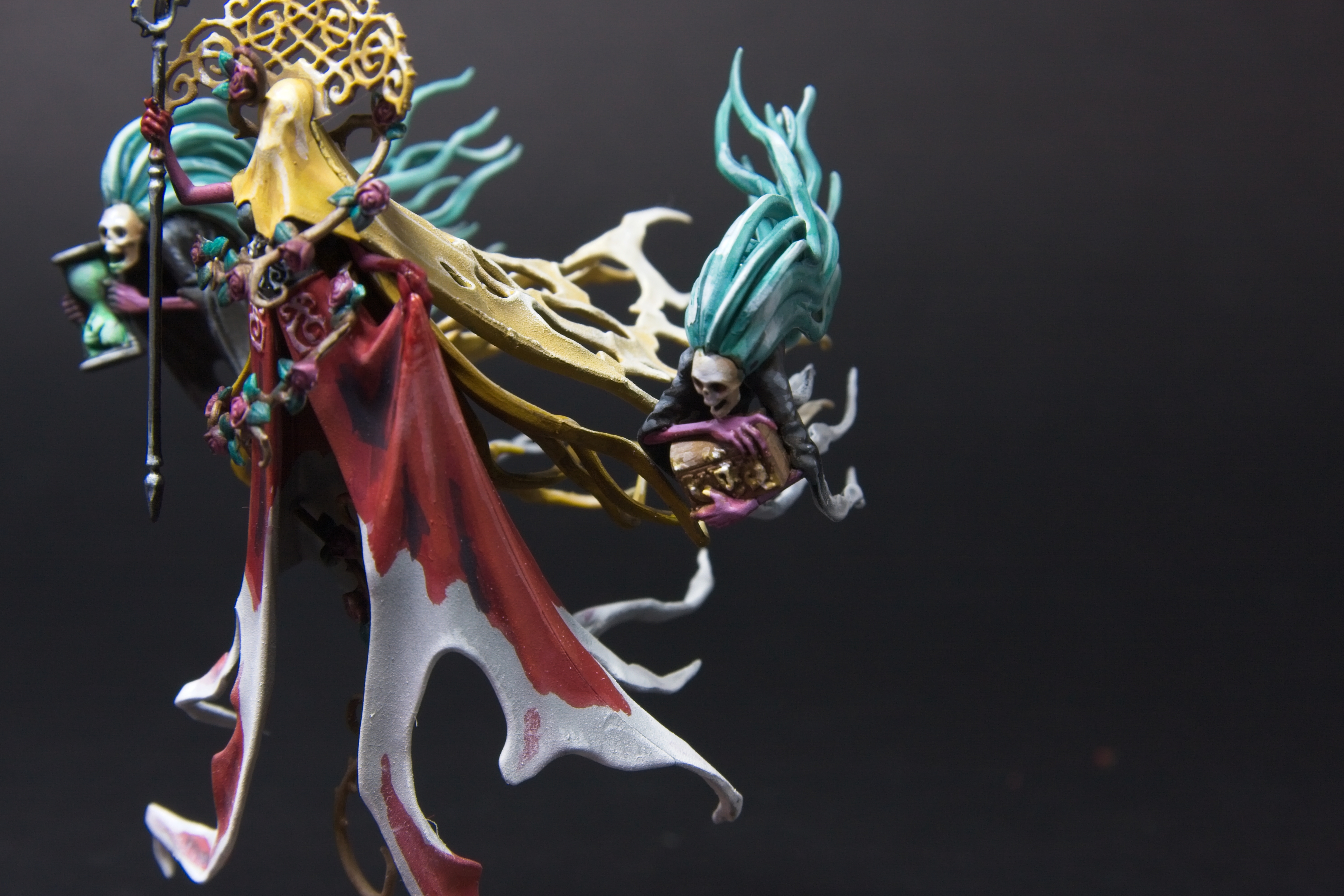 Olydner's left hand minion, with blue hair, holding a brown chest with a golden lock