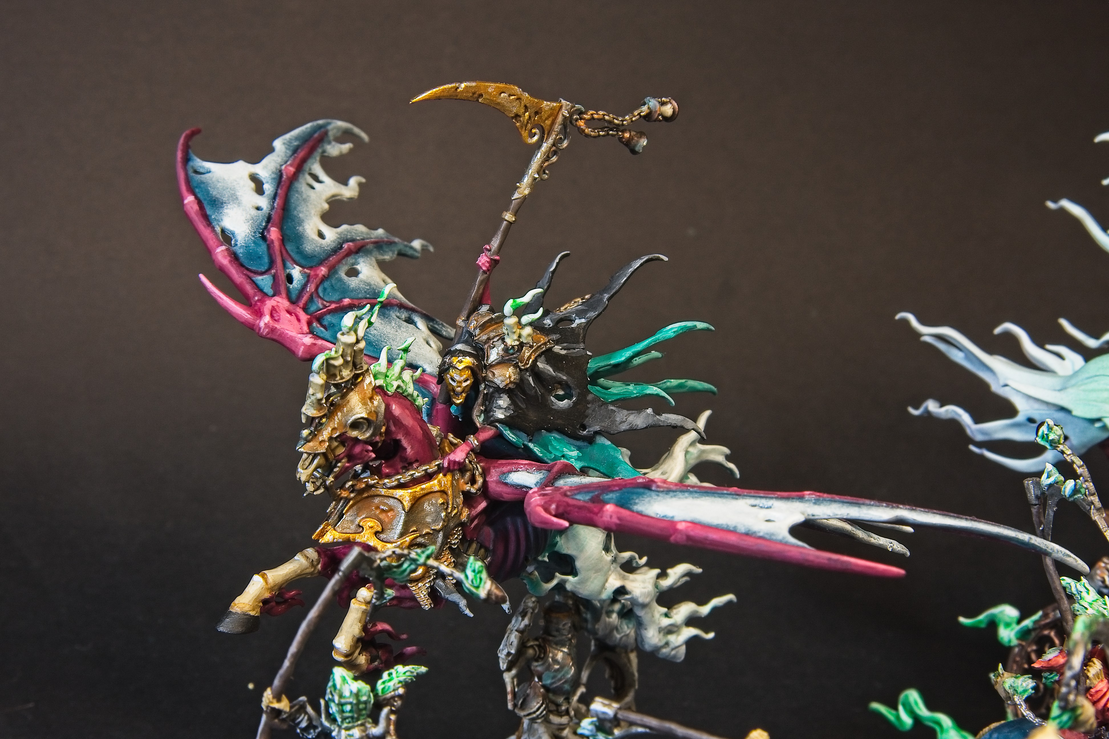 Reikenor's black cloak is striking against his rusted armor, golden scythe, and steed's falling apart armor.