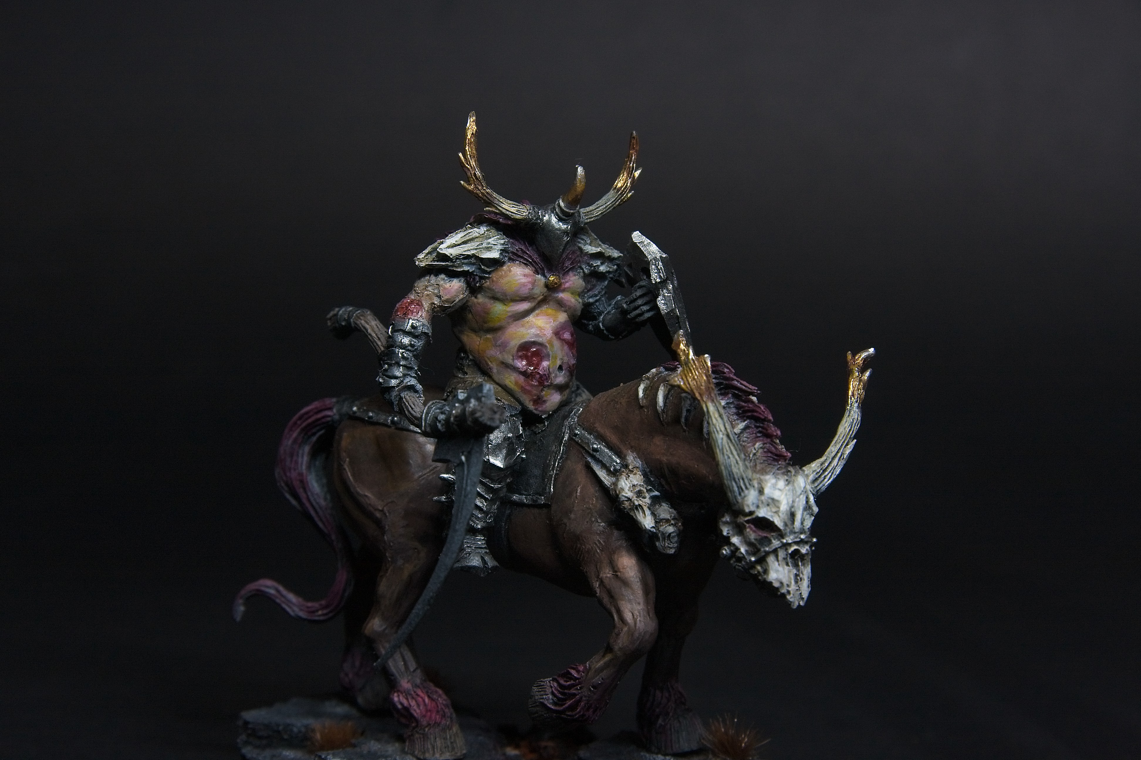 A mounted chaos lord, wielding a large sickle while riding a demonic horse.