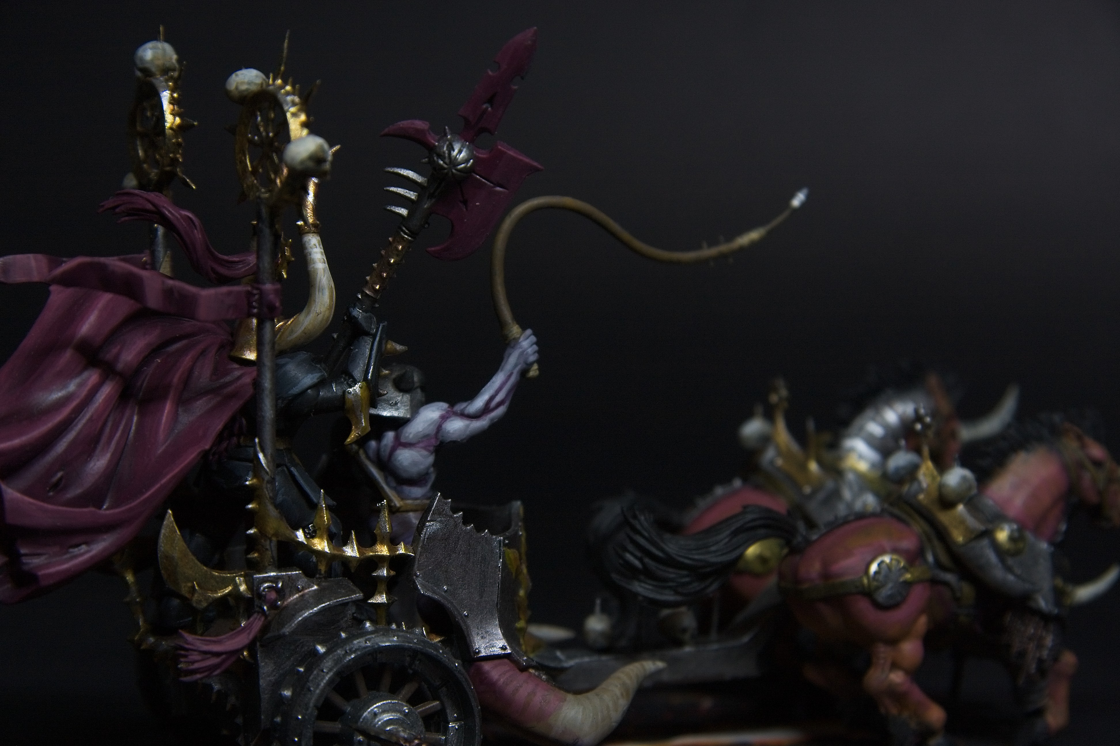 The lord's helper is purple and fleshy as he weilds a whip.