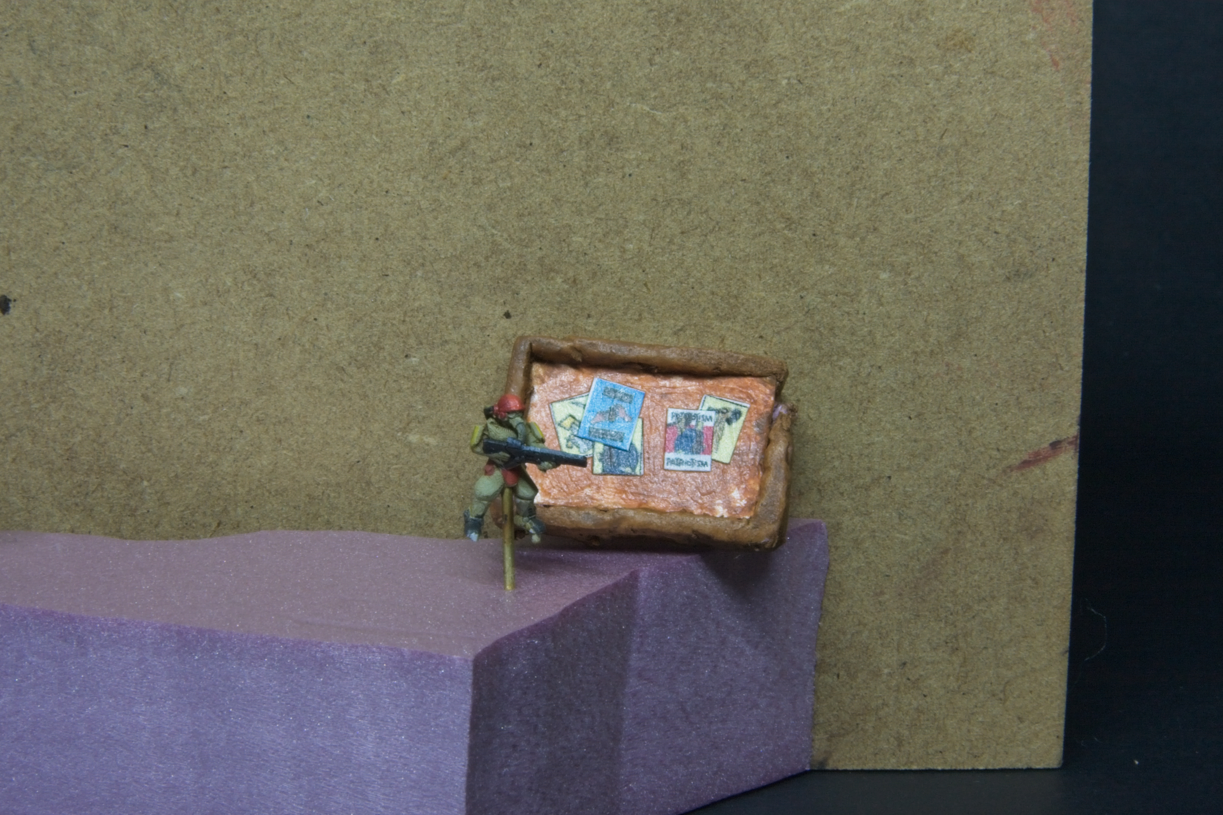 A soldier in front of a poster board