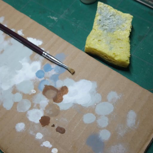 A piece of cardboard, a sponge, and a drybrush.