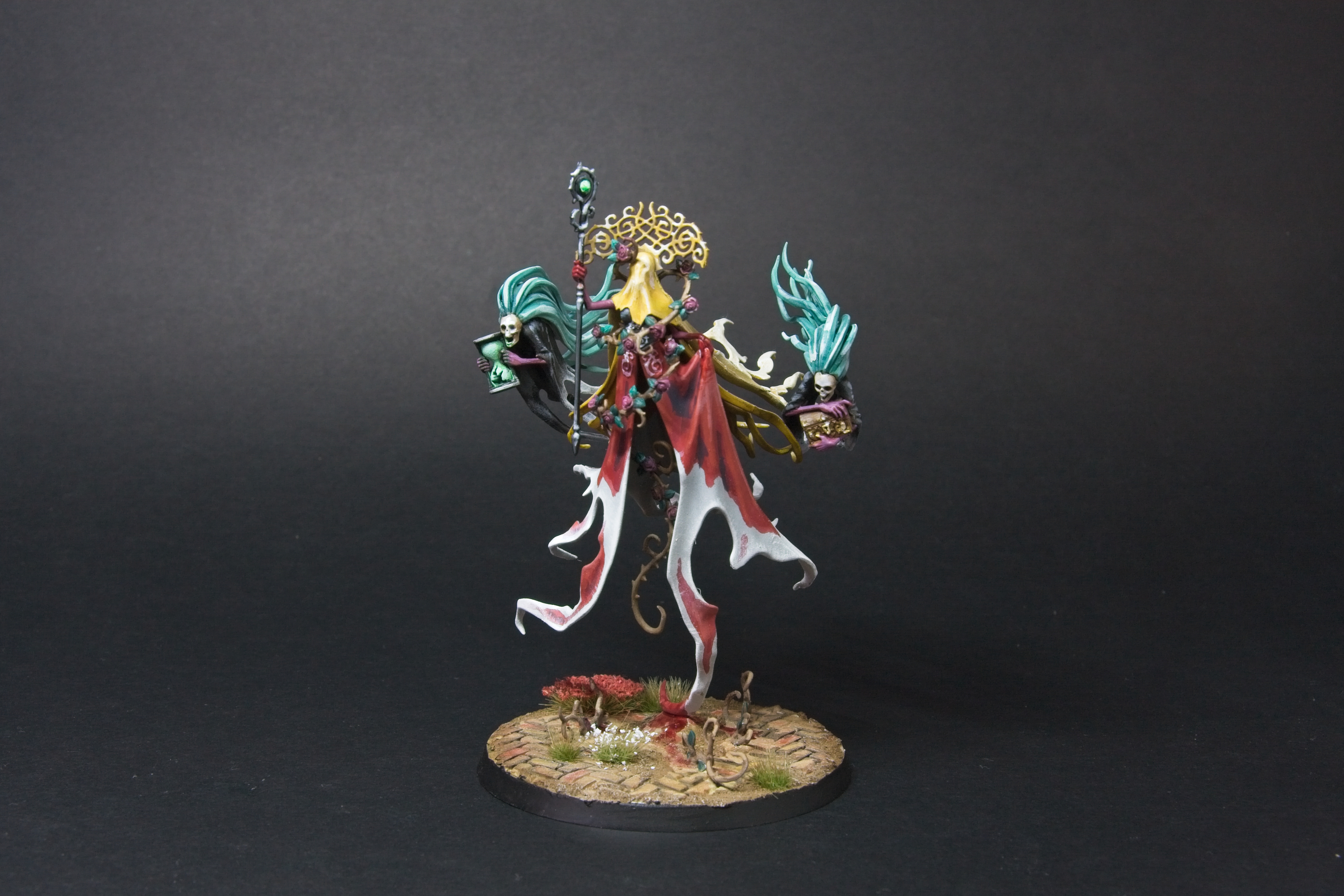 Lady Olynder, with a bloody red cloak, yellow veil, and golden crown.