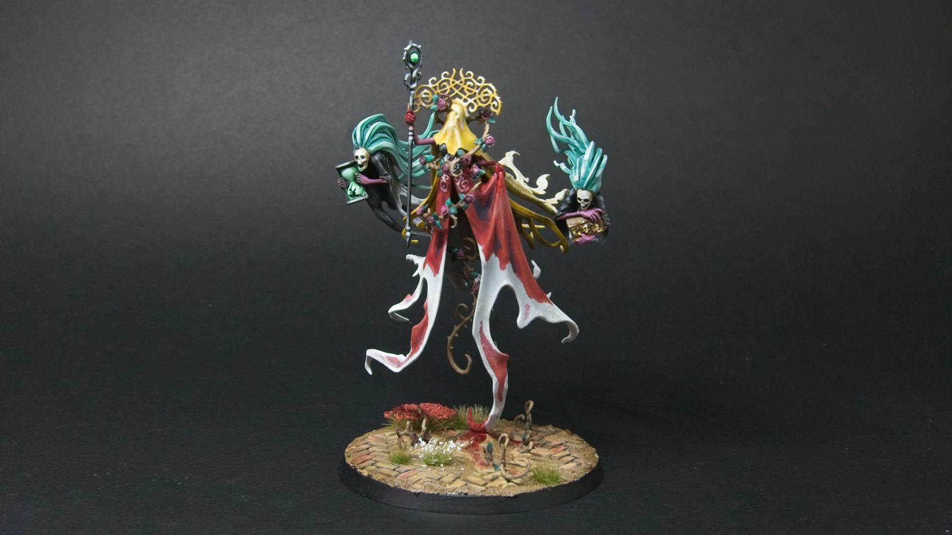 Lady Olynder, with a bloody red cloak, yellow veil, and golden crown.