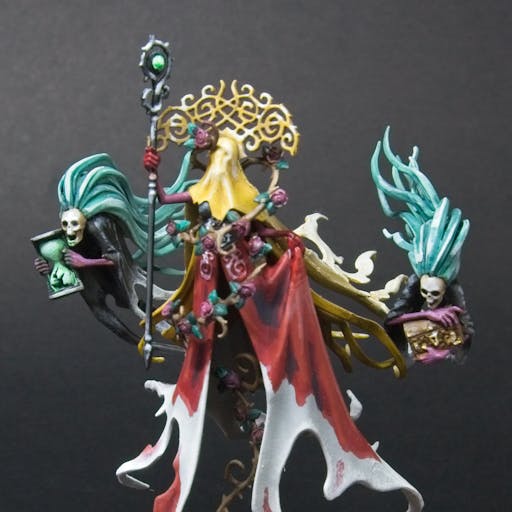 Lady Olynder, with a bloody red cloak, yellow veil, and golden crown.