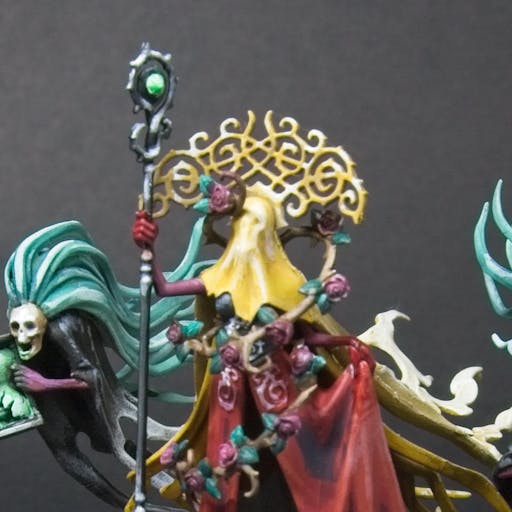 Lady Olynder, wrapped with rose vines, holding a silver staff with a green gem.