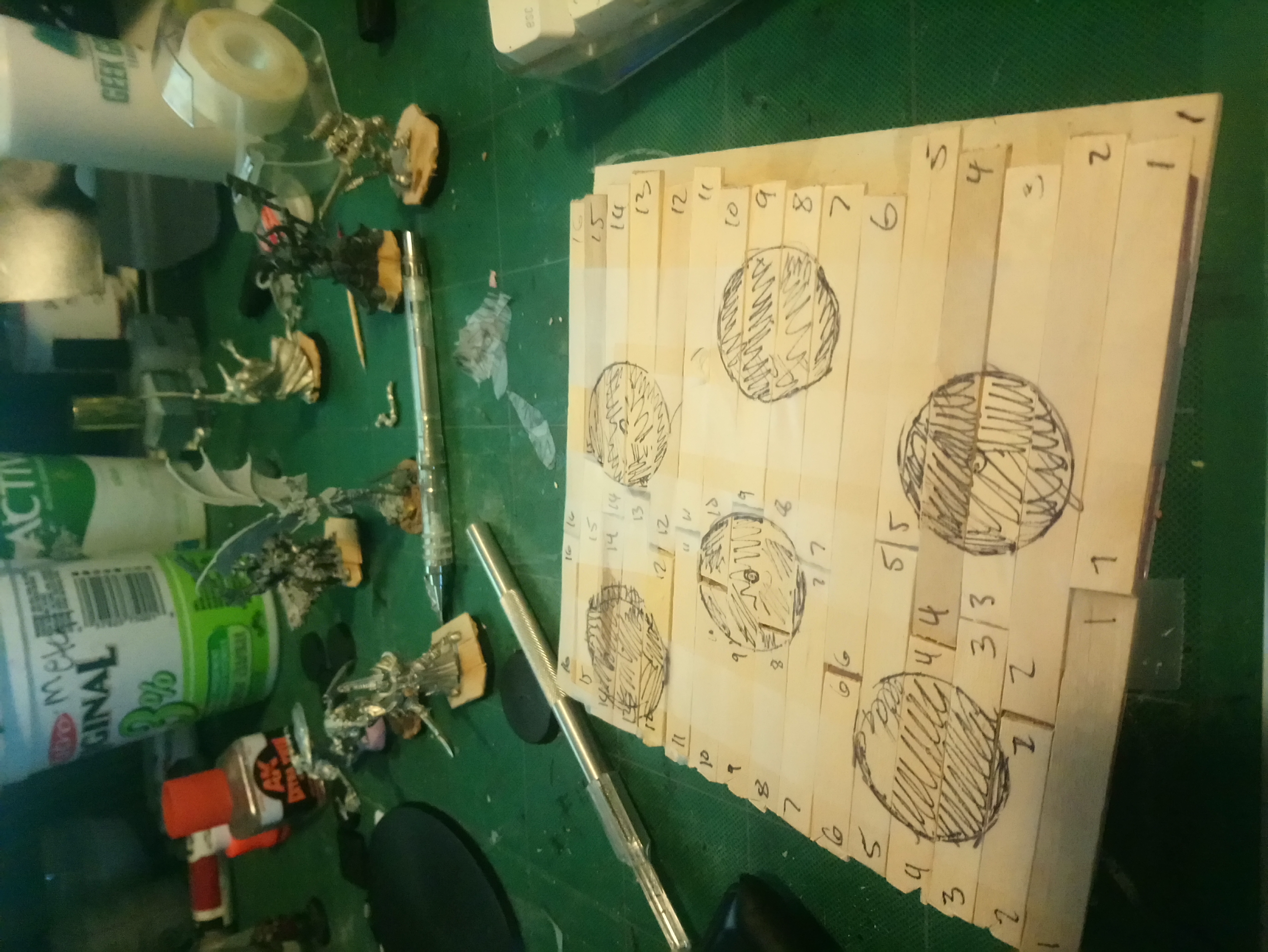 Popsicle sticks marked with holes marked for 6 minis