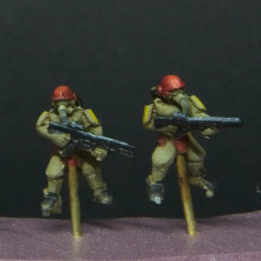 Tiny futuristic soldiers with yellow armor pads, and red helmets.