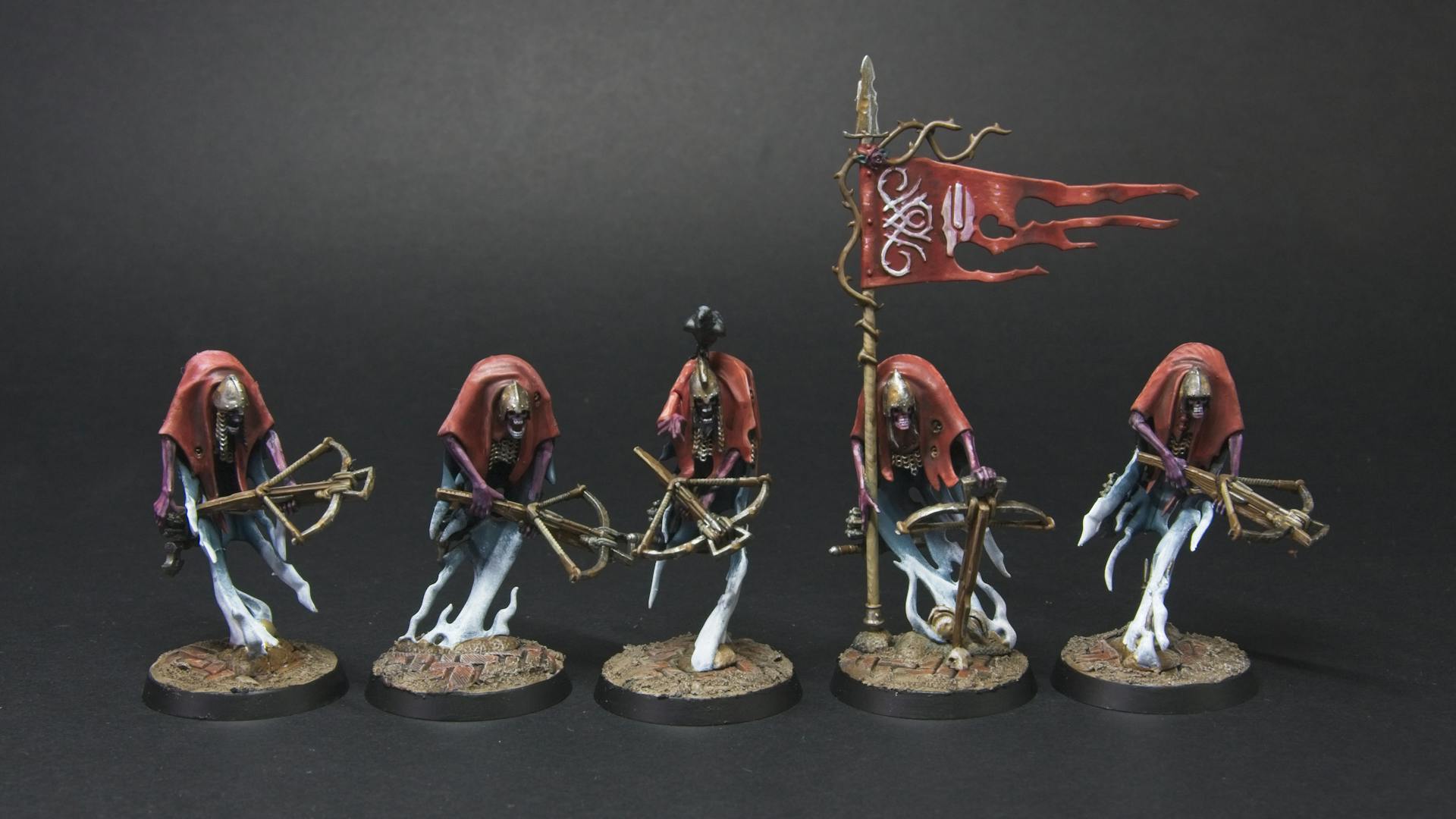Five spectral crossbow men, with red cloaks, rusty metallics, and a blue to white ghostly body.