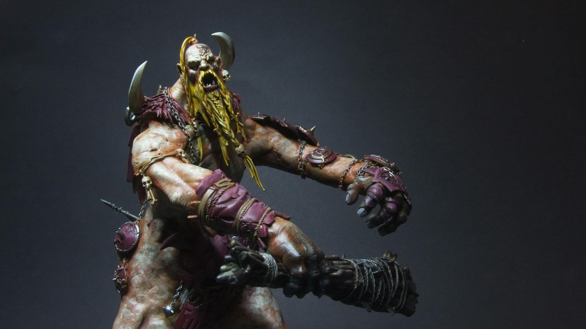 A mega-gargant, with pallid skin, purple clothes, and a yellow-gold beard.