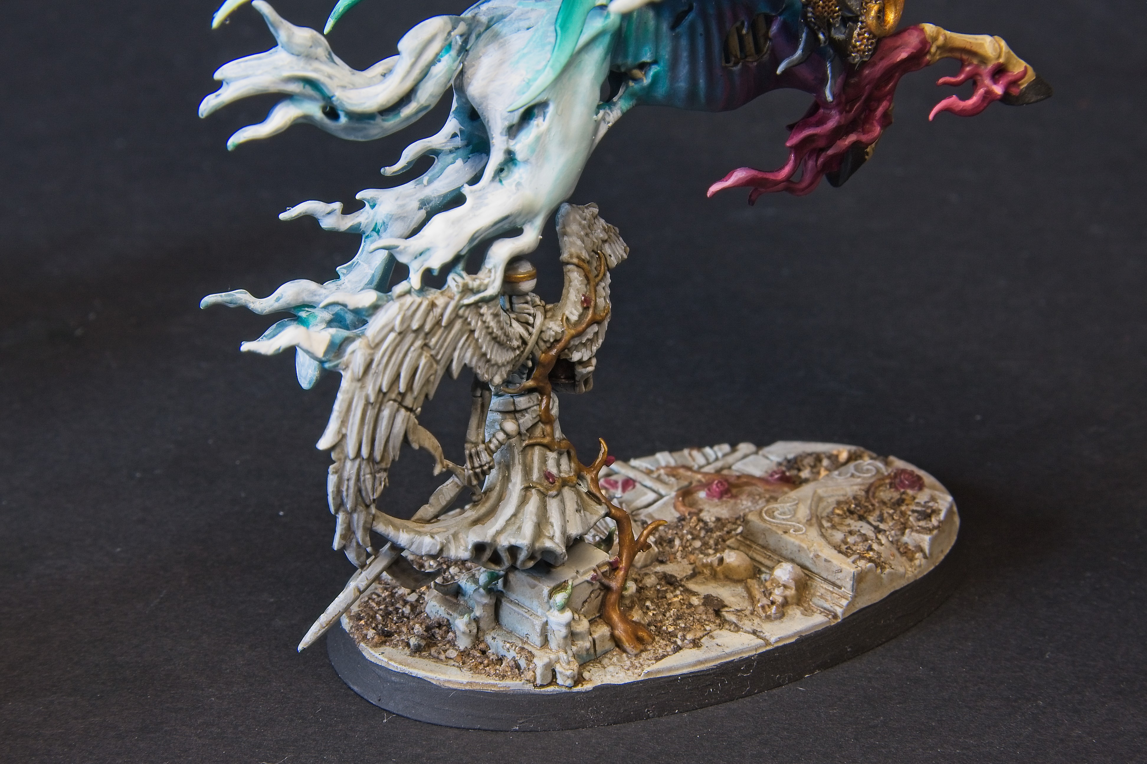 Reikenor's steed's back legs dissipate through a stone statue of an angel; cracked and overgrown with plants.