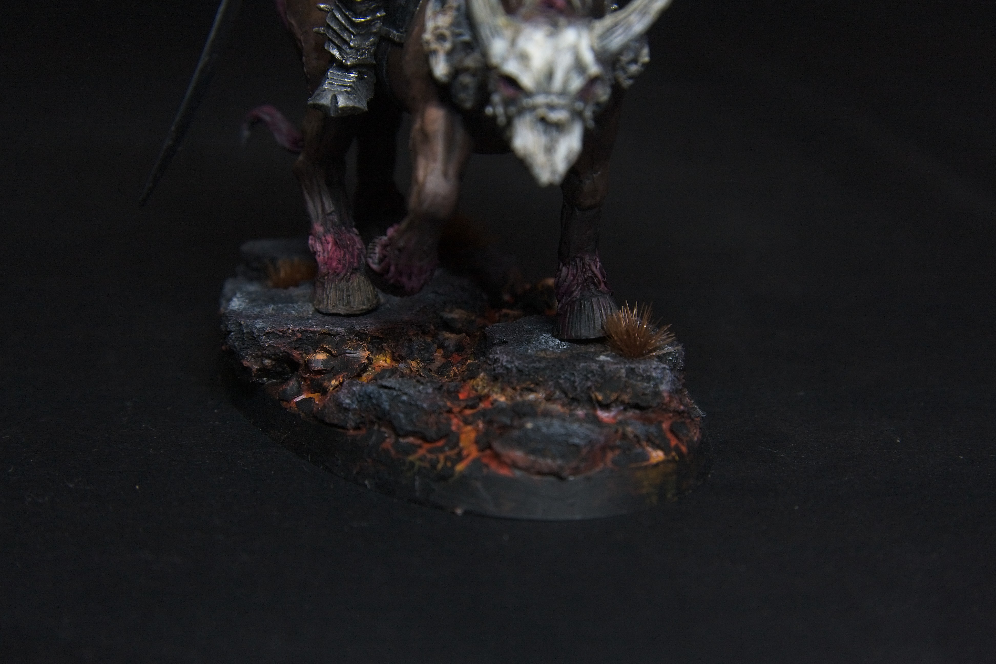 The ground he treads on is cracked and hot from the lava deep below.