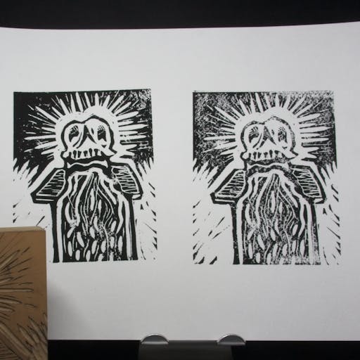 2 Skull lino prints on one piece of paper