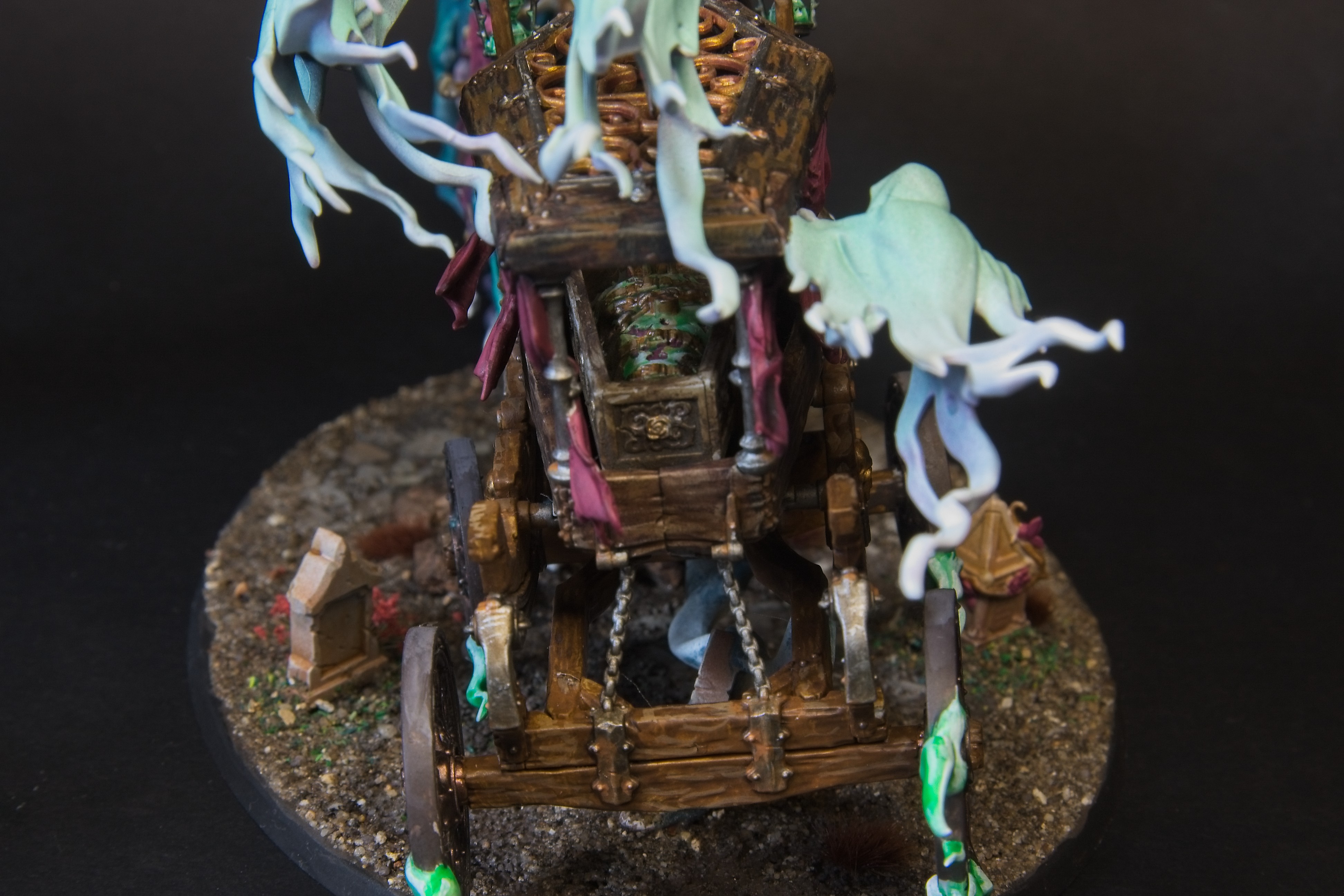 The black coach is host to a foul chained-up spirit, with three ghosts trailing behind.