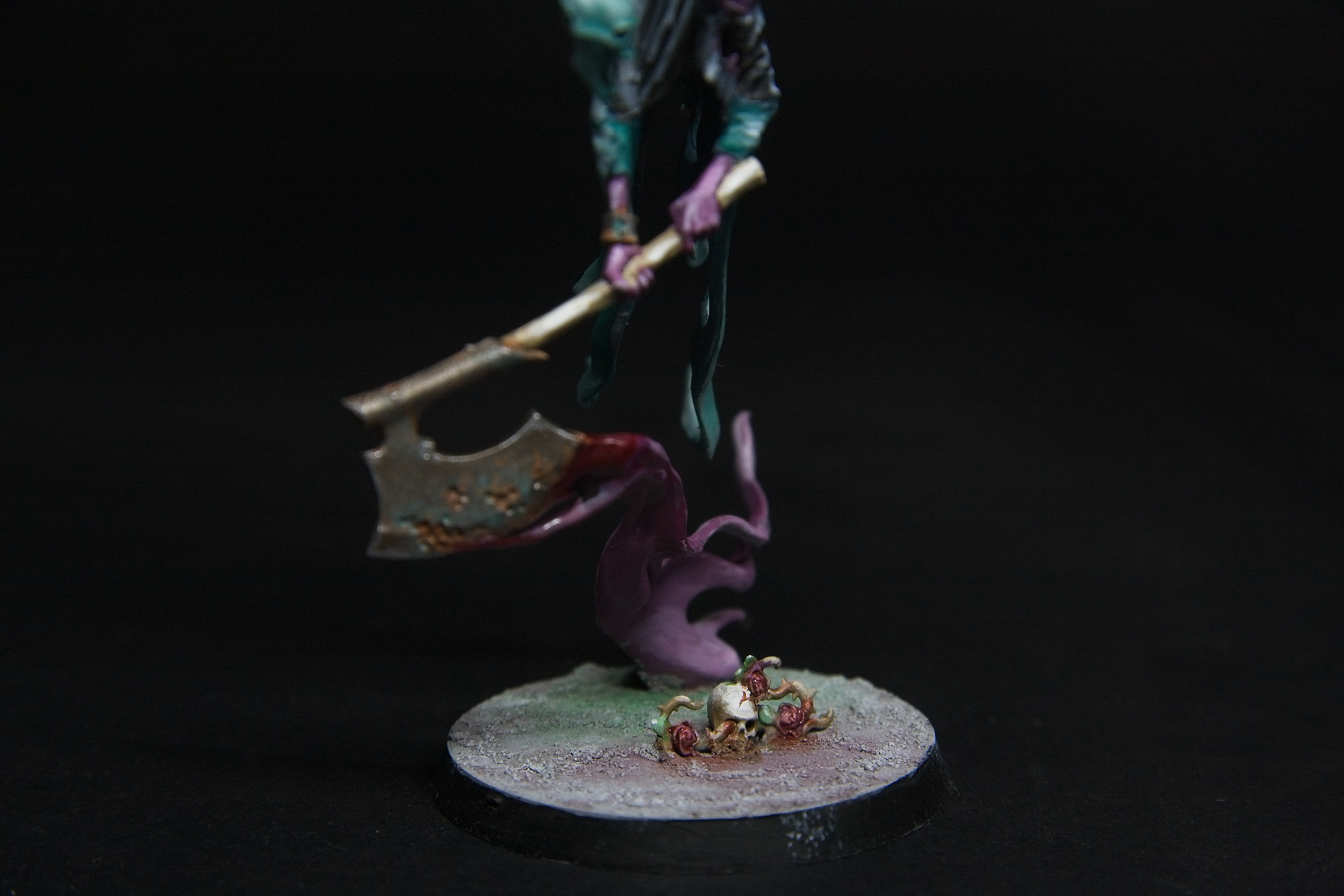 The blood spilled by his axe spring forth new life among the skulls.