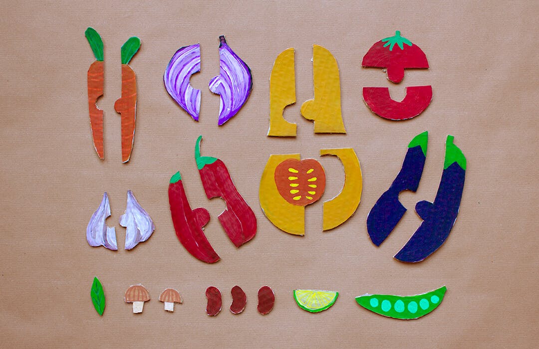 cardboard cutouts of vegetables in puzzle pieces