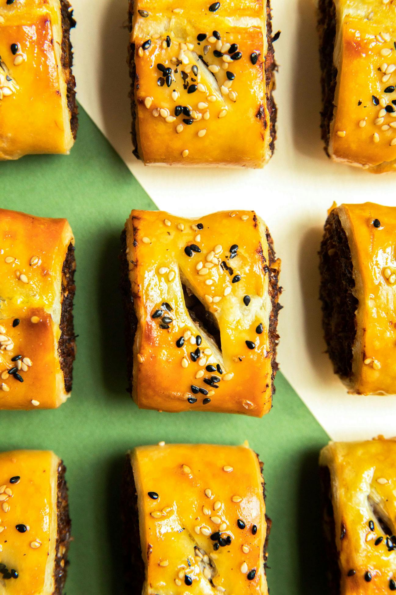 sausage rolls on green patterned background