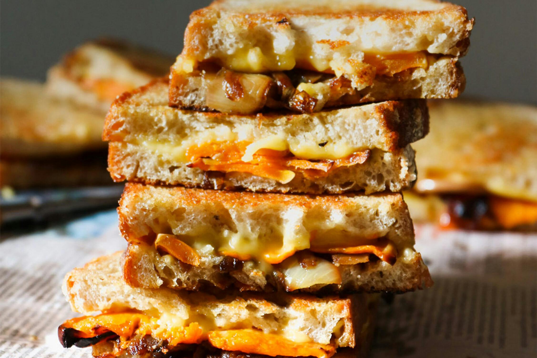 pumpkin and caramelised onion toasties stacked on top of each other