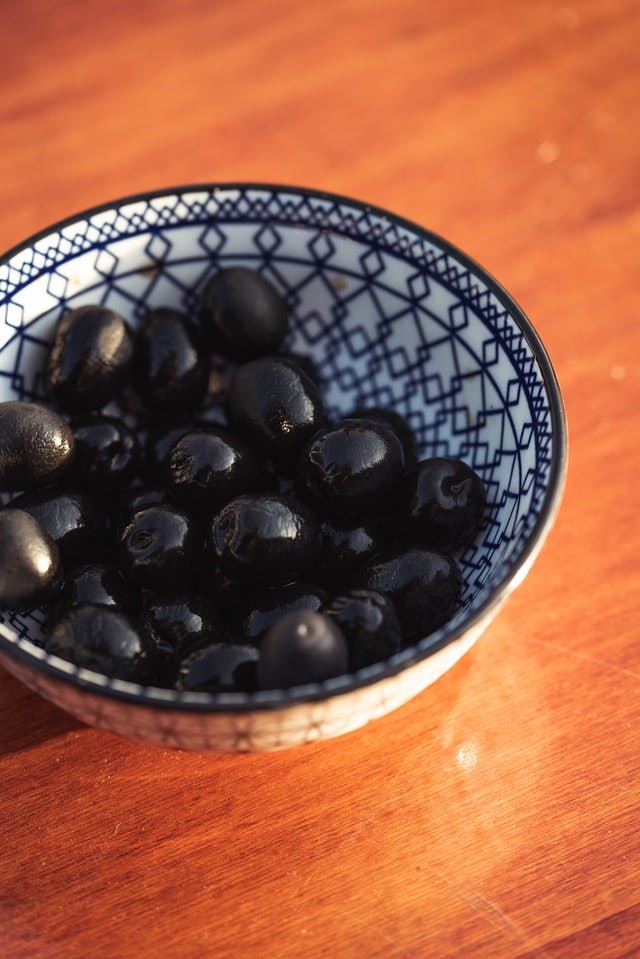 bowl of olives on wooden table