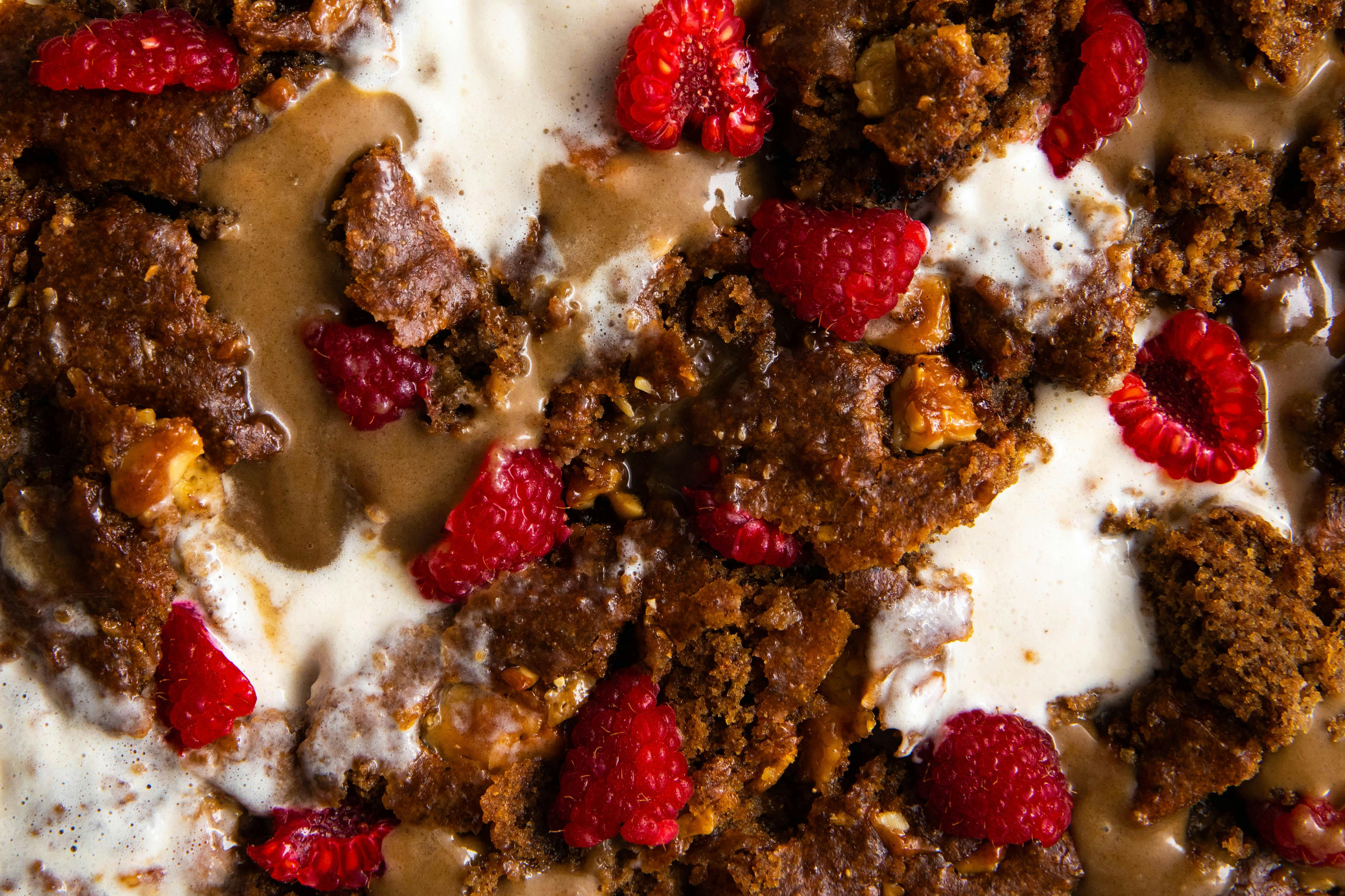 close shot of blondies with salted caramel and raspberries