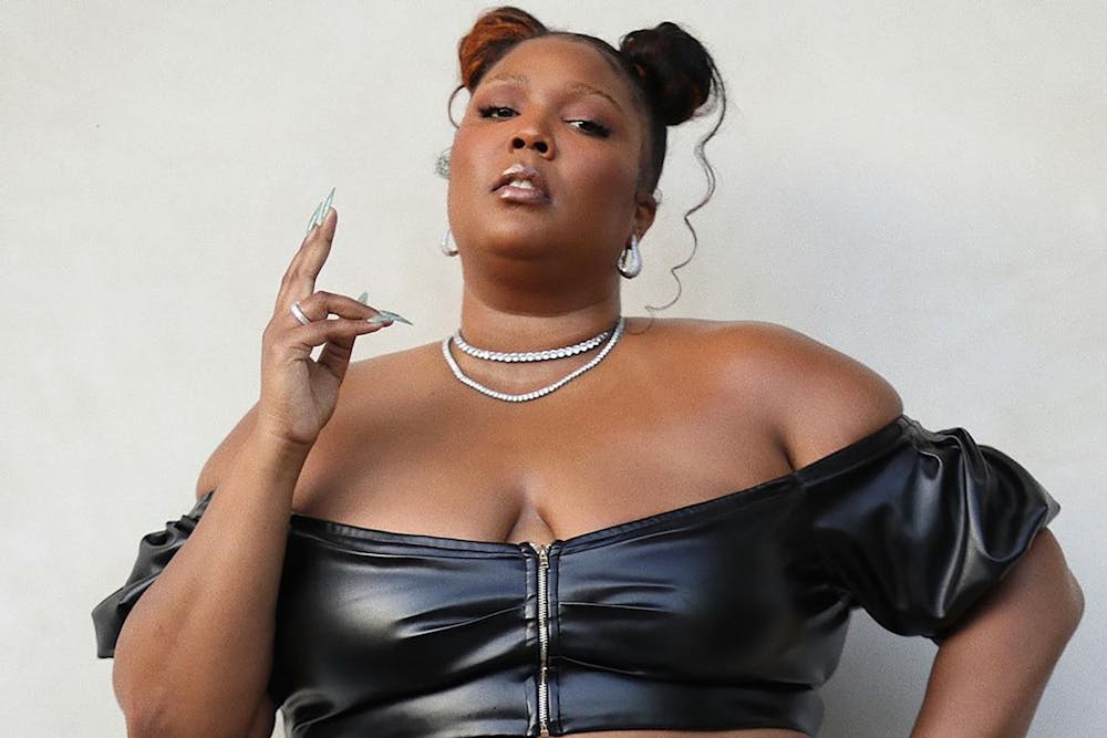 Lizzo flaunts curves in tight black leather crop top and pants
